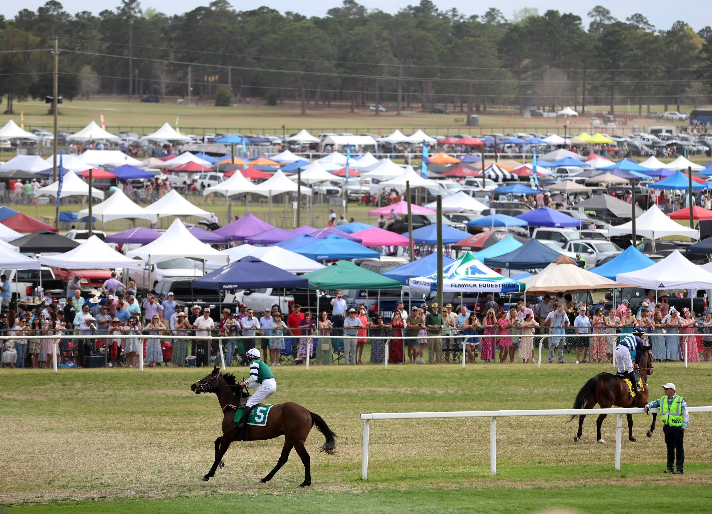 Thousands of spectators gather around as the Jockeys and horses prepare to enter the field for the final race of the Carolina Cup.