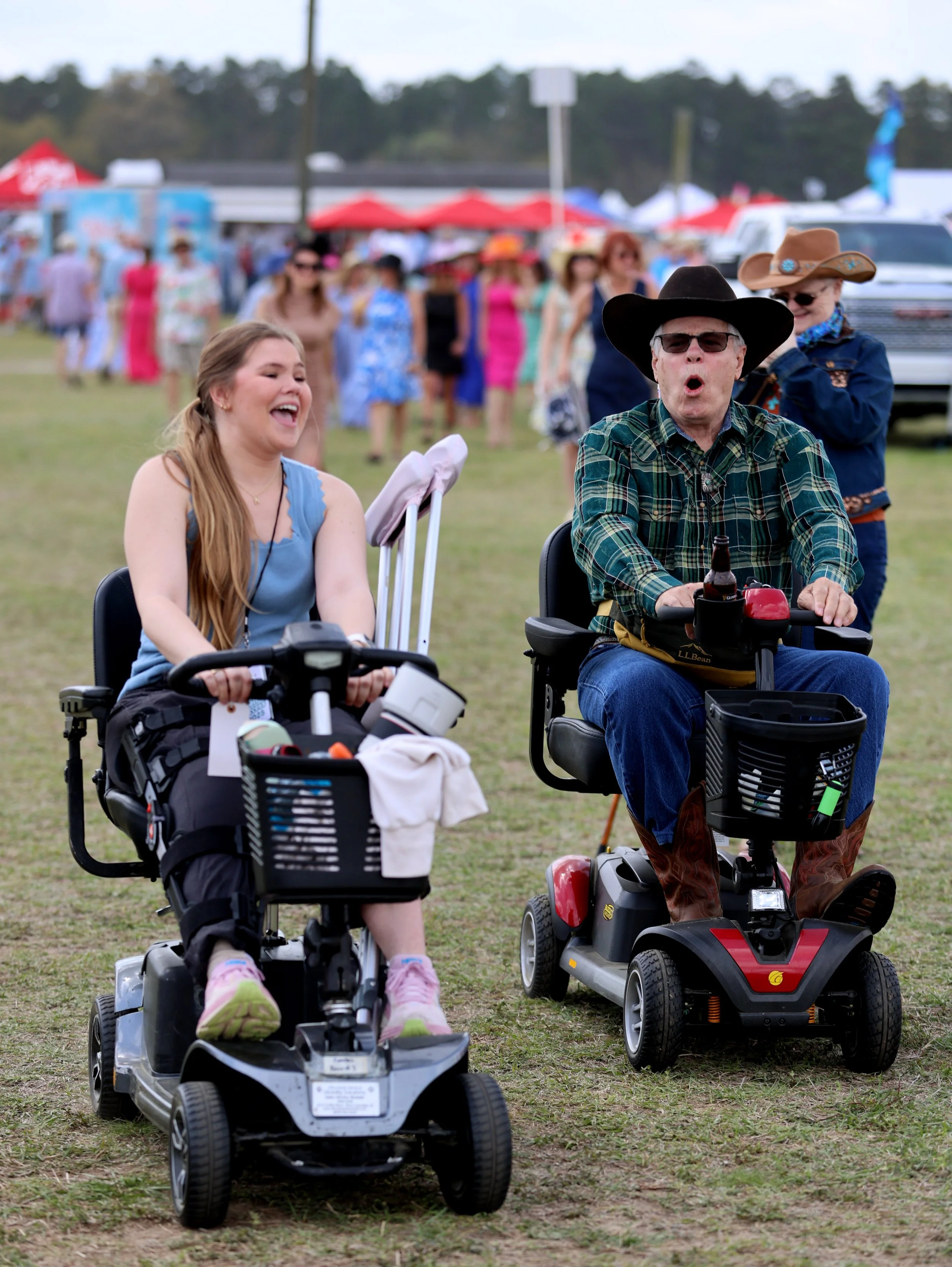 Augusta Lewis, of Greenville, SC, and Kirk Long, of Kershaw, SC, race each other as they share a bond over their mobility scooters.