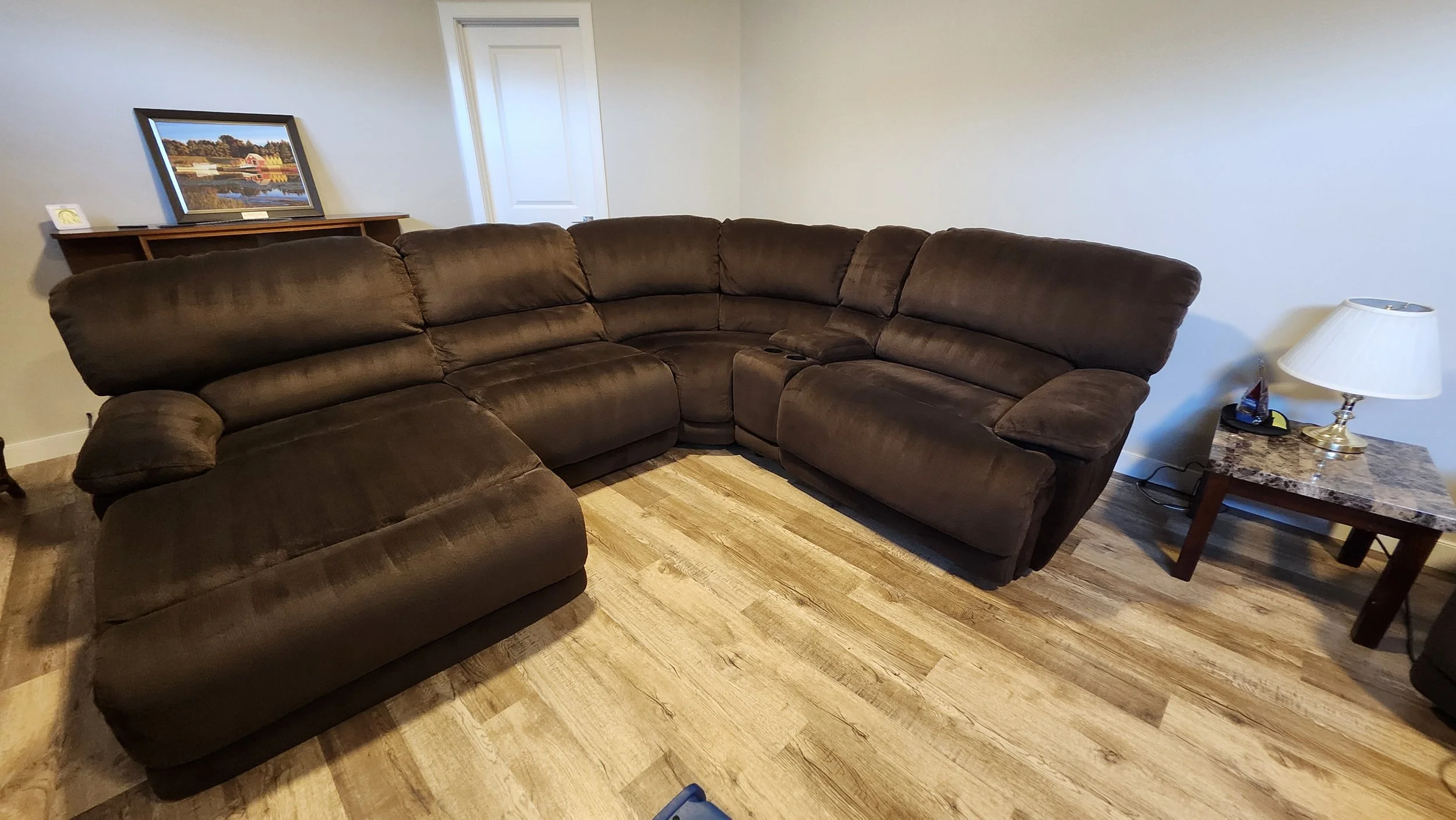 A brown sectional sofa that has been skillfully cleaned with hot water extraction or steam cleaning
