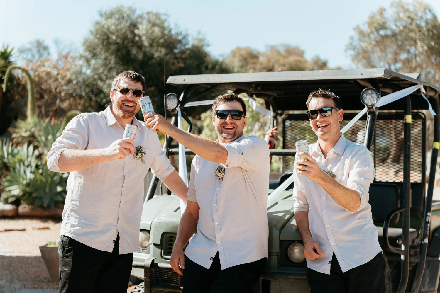 Groomsmen celebrating with a drink