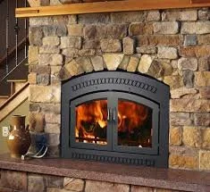 A wood-burning fireplace with a stone surround and burning fire inside.