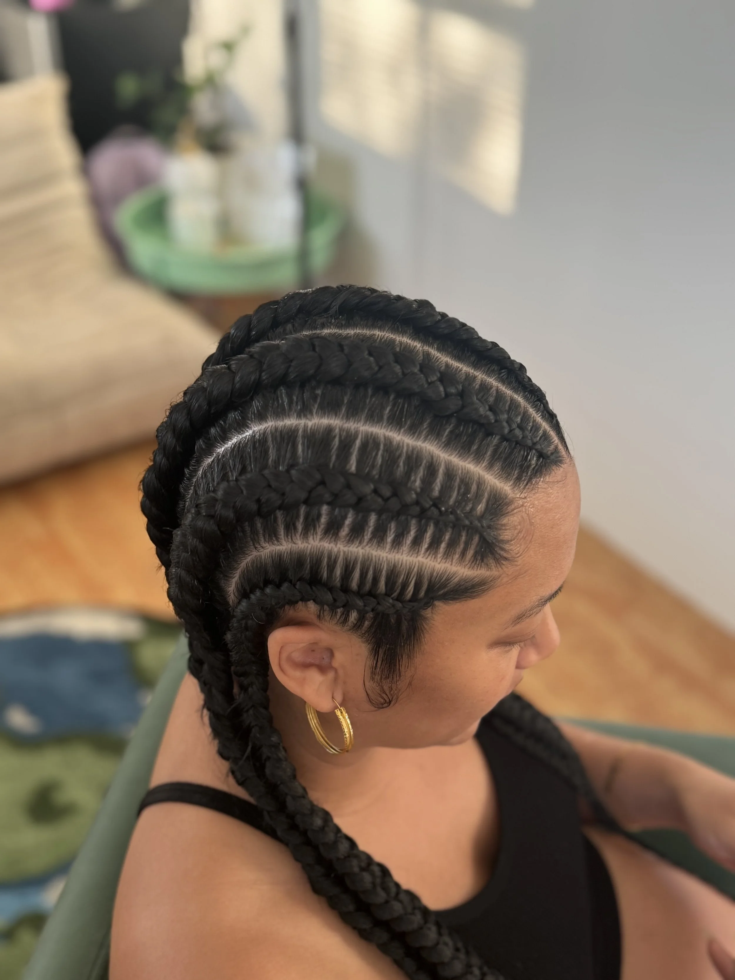 Woman with freshly braided 6 cornrows with feed ins for length