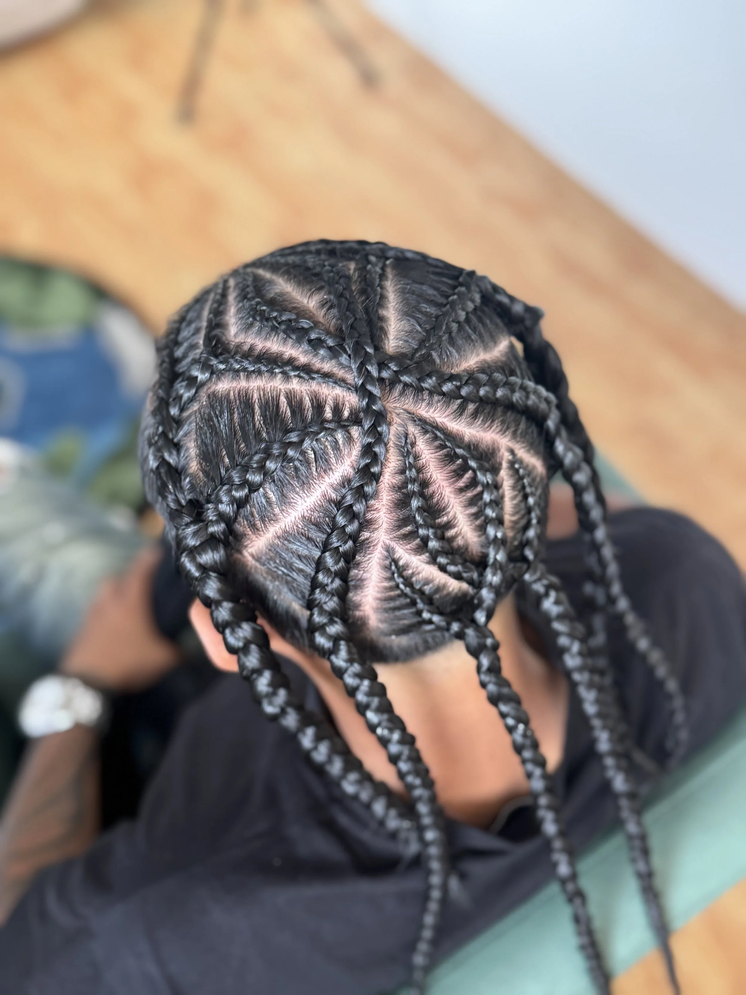 Top view of a person with neatly braided hair styled in a freestyle braids