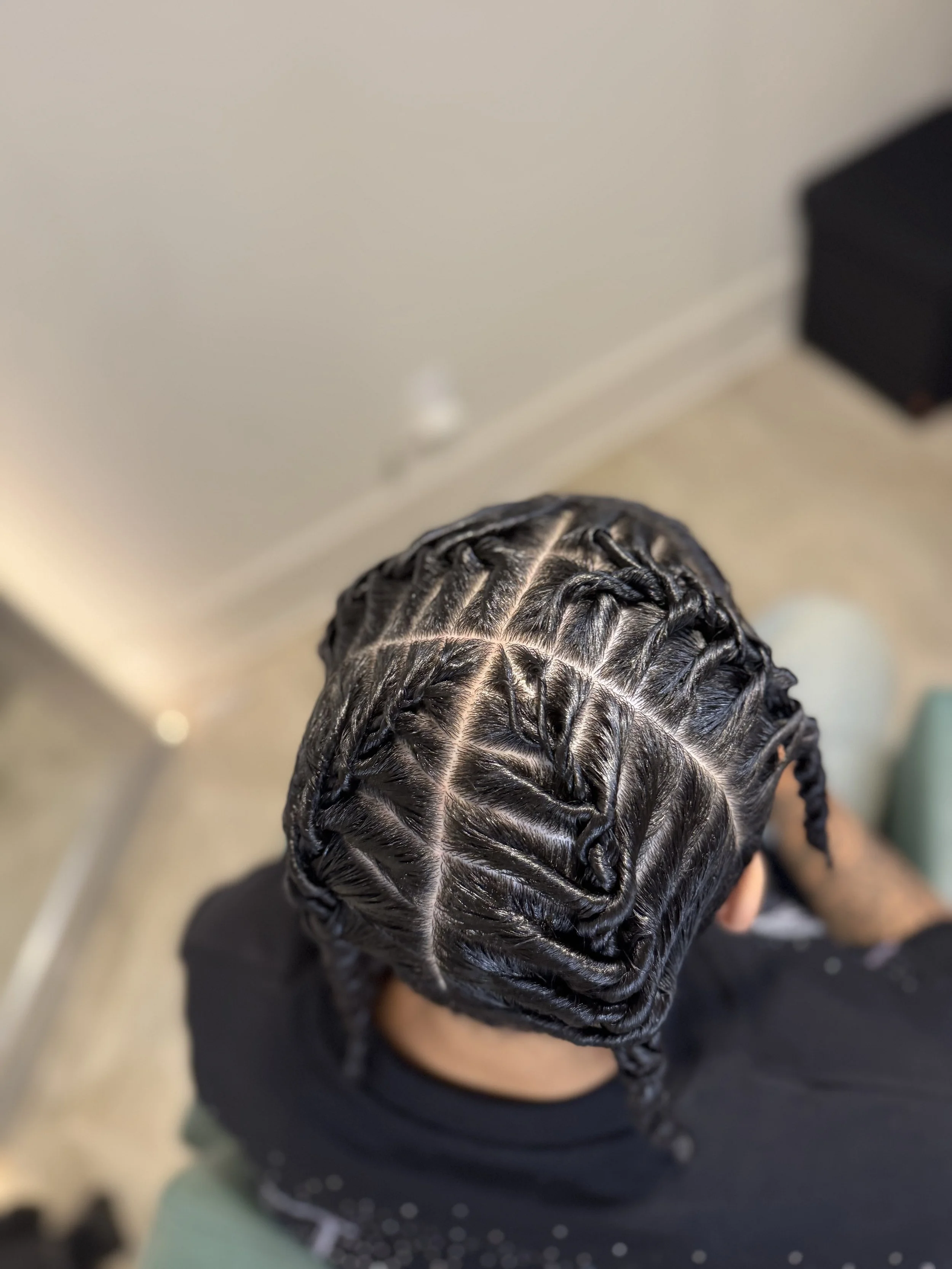 Top-down view of a person's head showcasing freshly styled barrel twists
