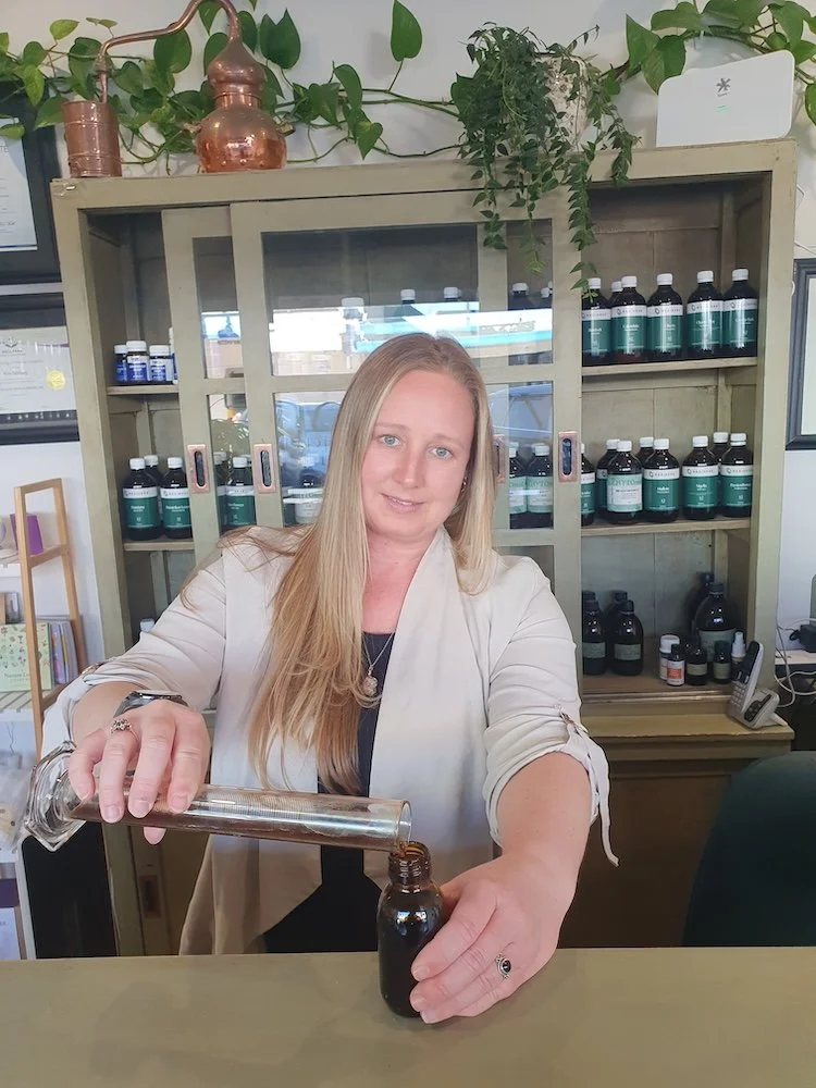 Dispensing custom herbal liquid medicine at The Herbary in Pukekohe, Auckland, showing personalised naturopathic care and in-house herbal compounding.