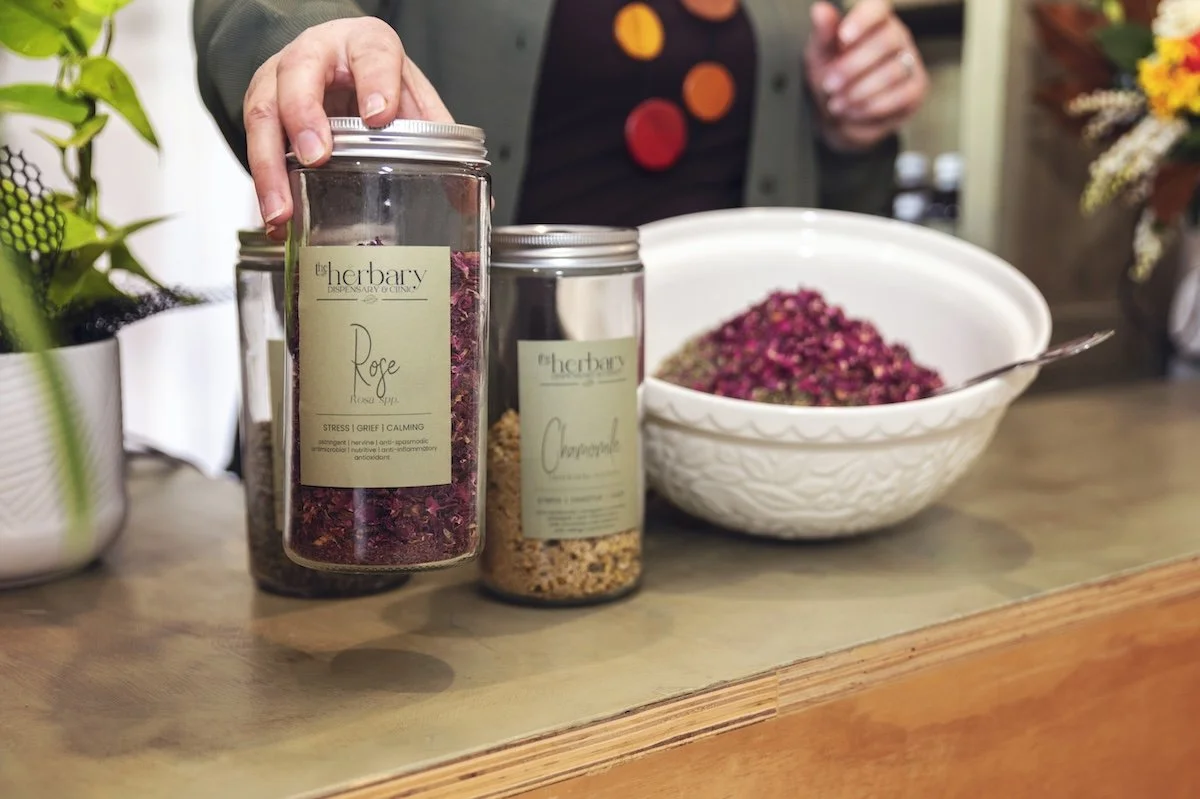 Jar of dried rose petals labelled Herbary Rose, prepared at The Herbary in Pukekohe, Auckland, showcasing handcrafted herbal medicine and natural health remedies.