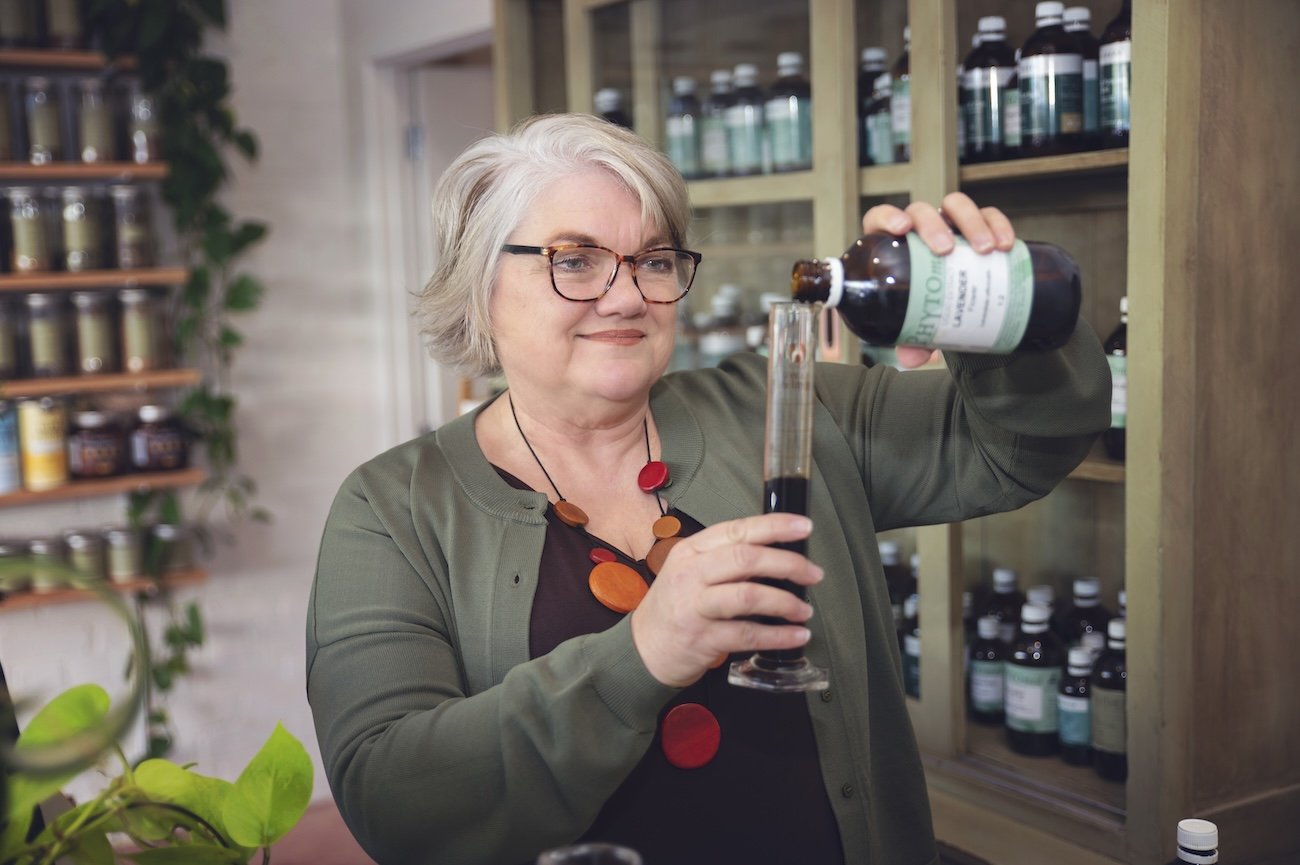 Naturopath preparing a custom herbal liquid extract at The Herbary in Pukekohe, Auckland, using traditional herbal medicine and personalised naturopathic care.