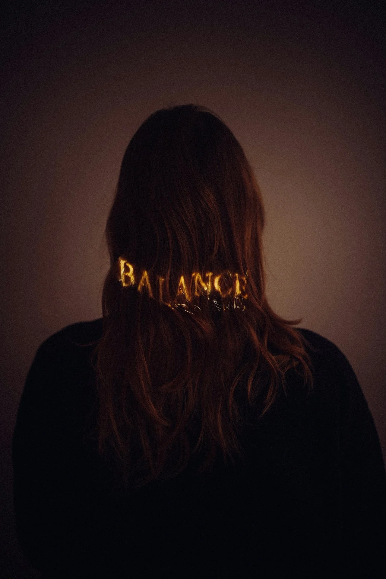 Woman with Balance text projected in hair - This Is Not Therapy