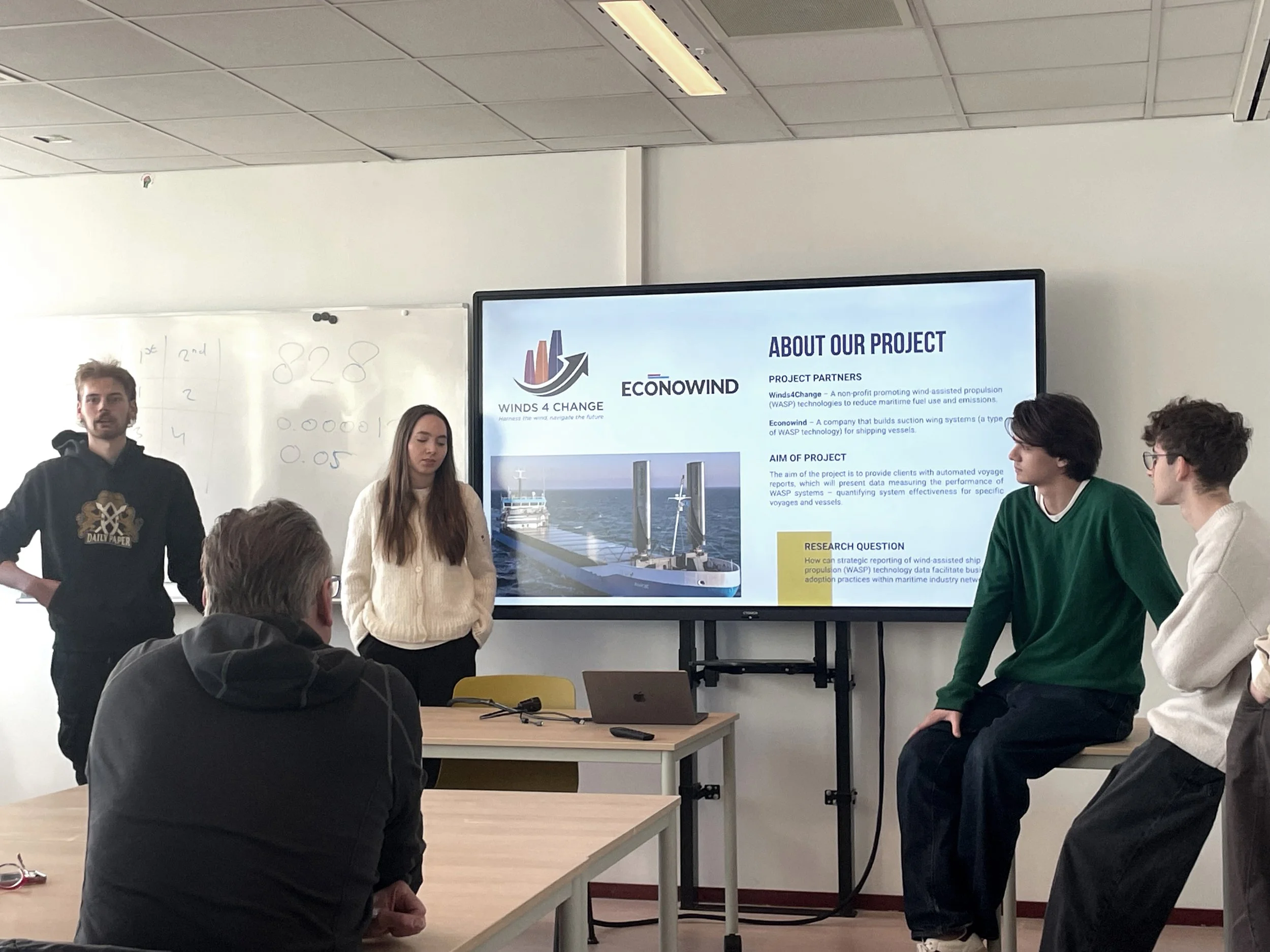 Students in a workshop in front of the presentation