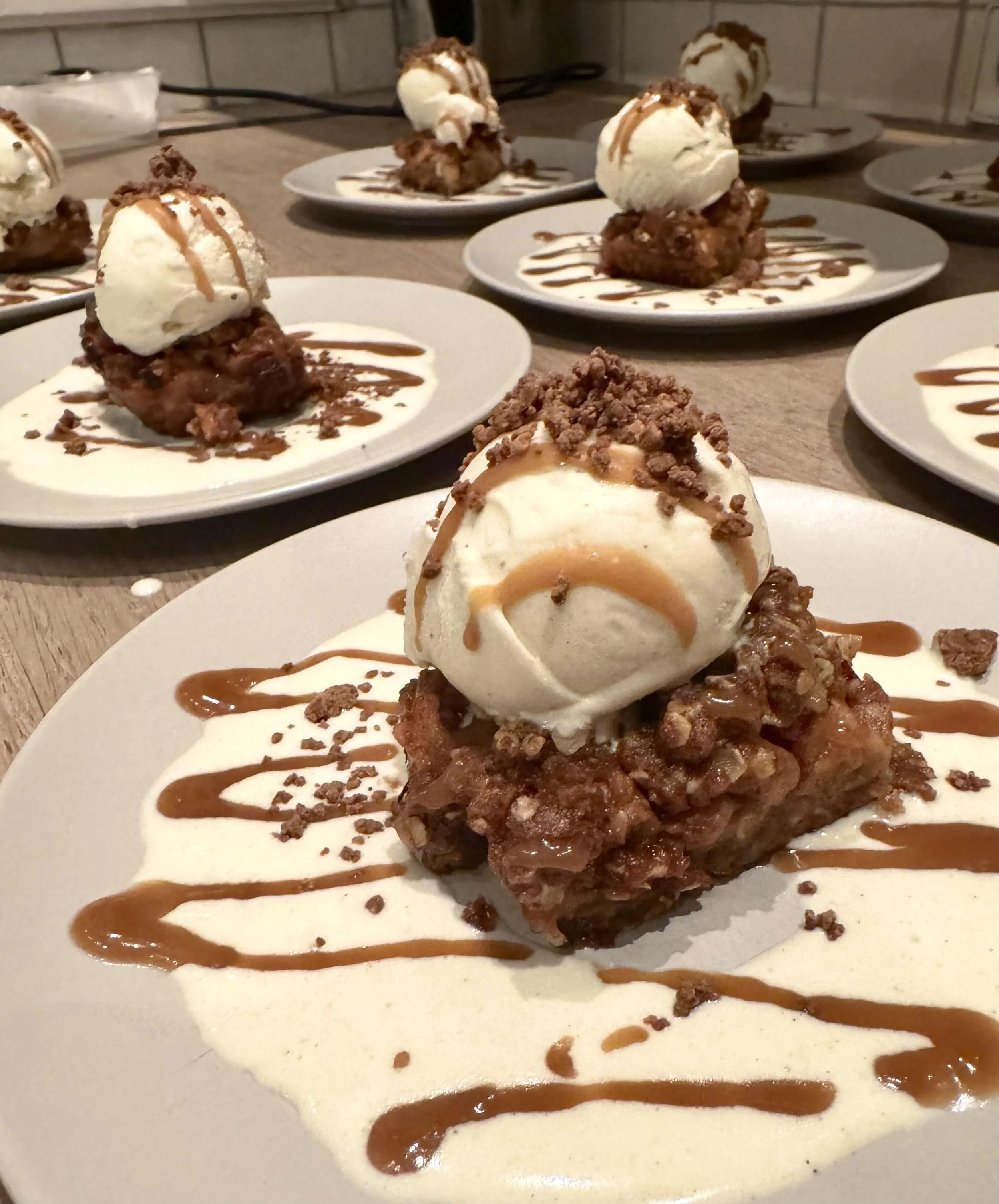 Elegant plated dessert with vanilla ice cream and warm chocolate sauce poured tableside during a private dining event in Amsterdam by Chef Adrienne