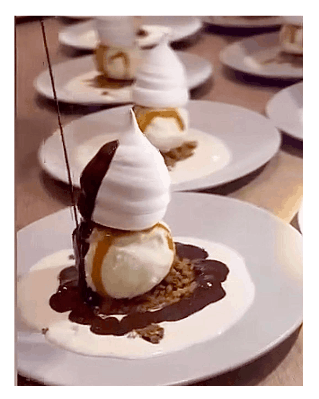Elegant plated dessert with vanilla ice cream and warm chocolate sauce poured tableside during a private dining event in Amsterdam by Chef Adrienne