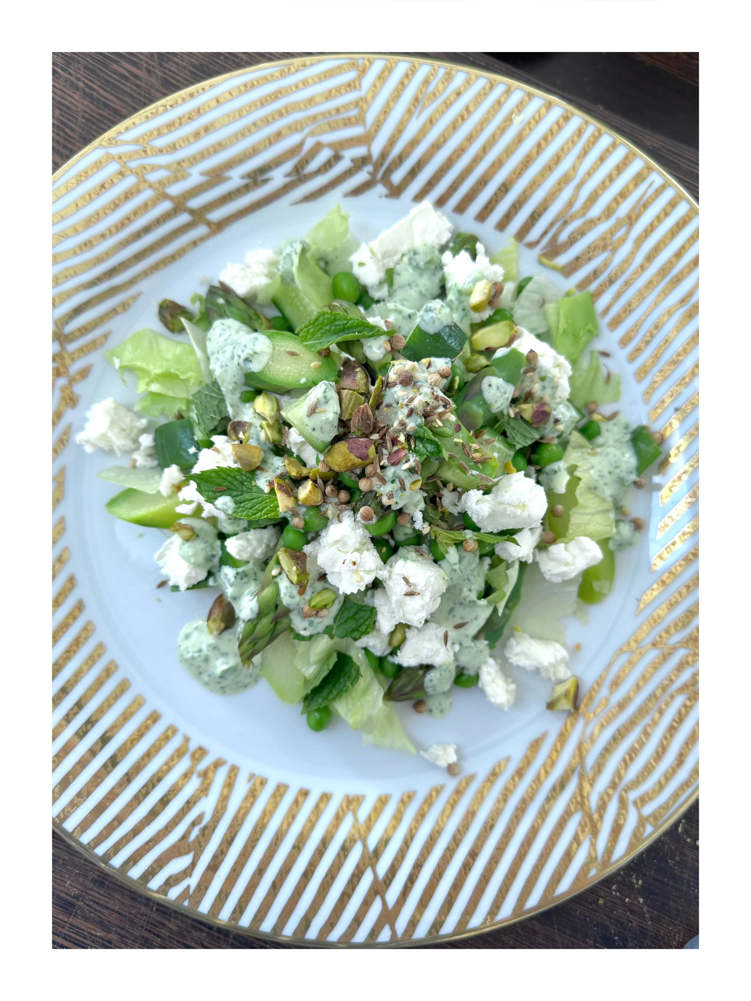 Seasonal salad with fresh herbs, vegetables, and cheese from Chef Adrienne’s private dining menu.
