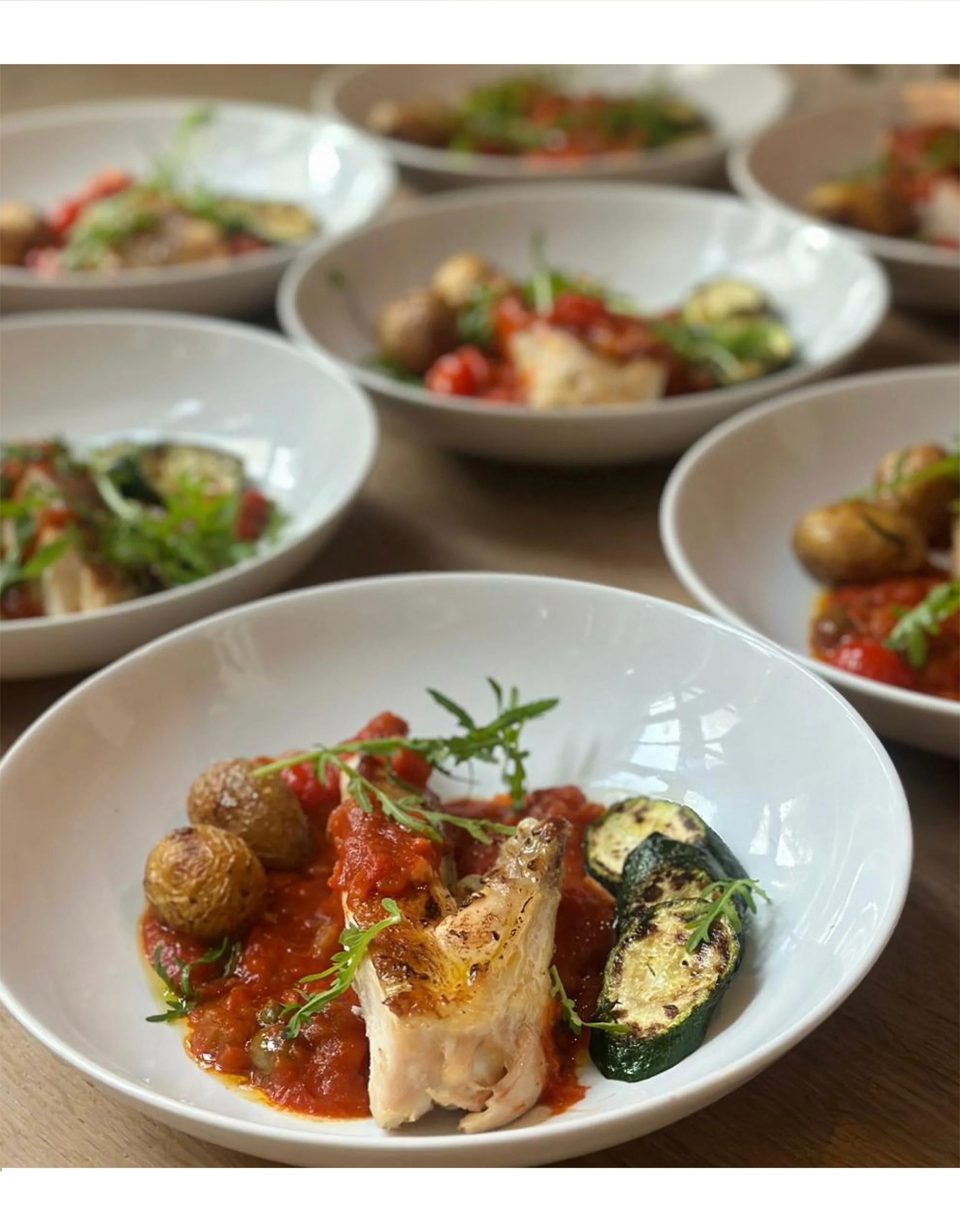 Seasonal fish dish with roasted vegetables and tomato sauce from Chef Adrienne’s private dining menu in Amsterdam.