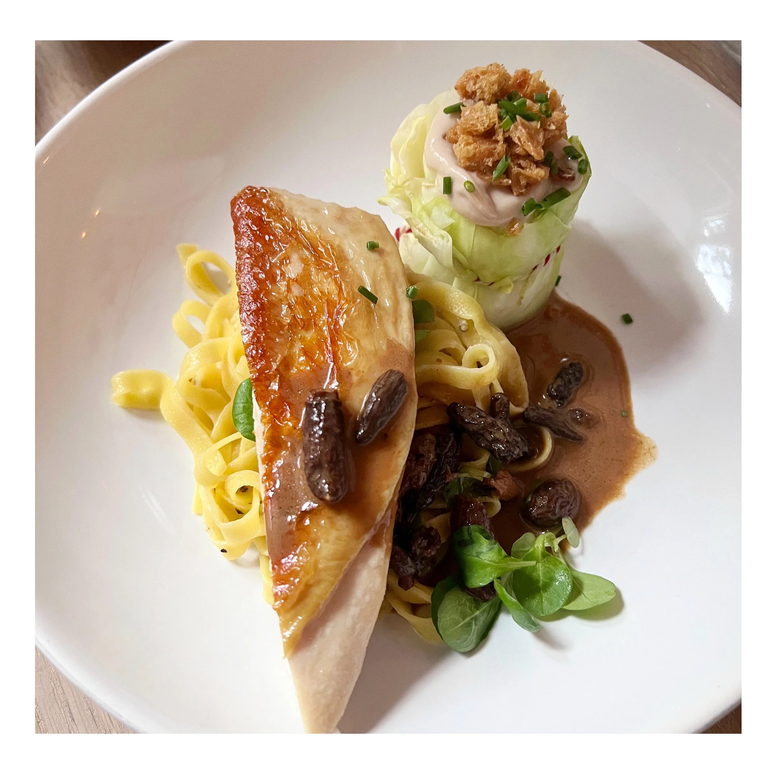 Seasonal poultry dish served with fresh pasta, mushrooms, and sauce as part of Chef Adrienne’s intimate dining menu.