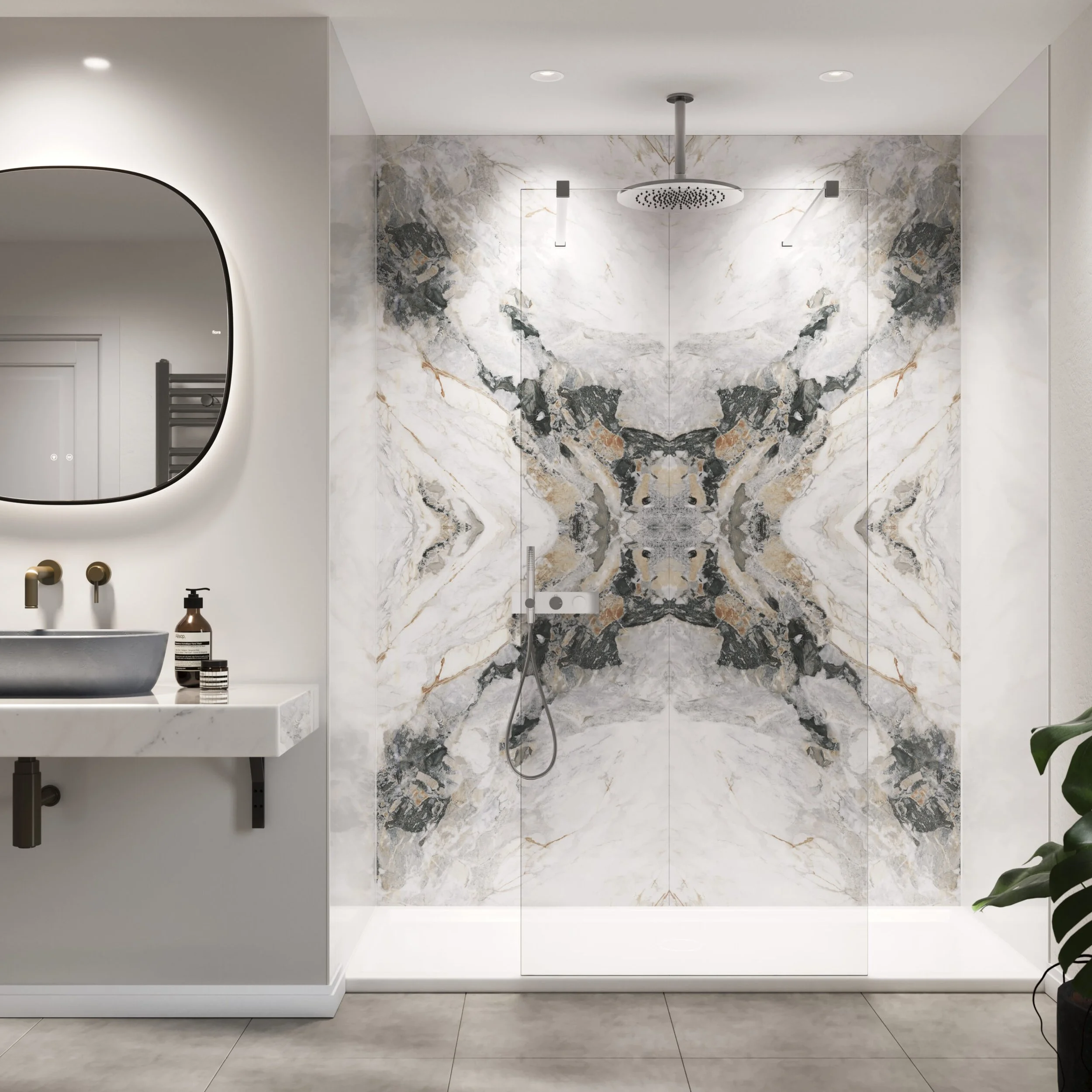Modern bathroom with a marble shower stall featuring symmetrical black, gray, and brown veining. A white vanity with a vessel sink, a mirror, and accessories are on the left. A green plant is partially visible on the right.