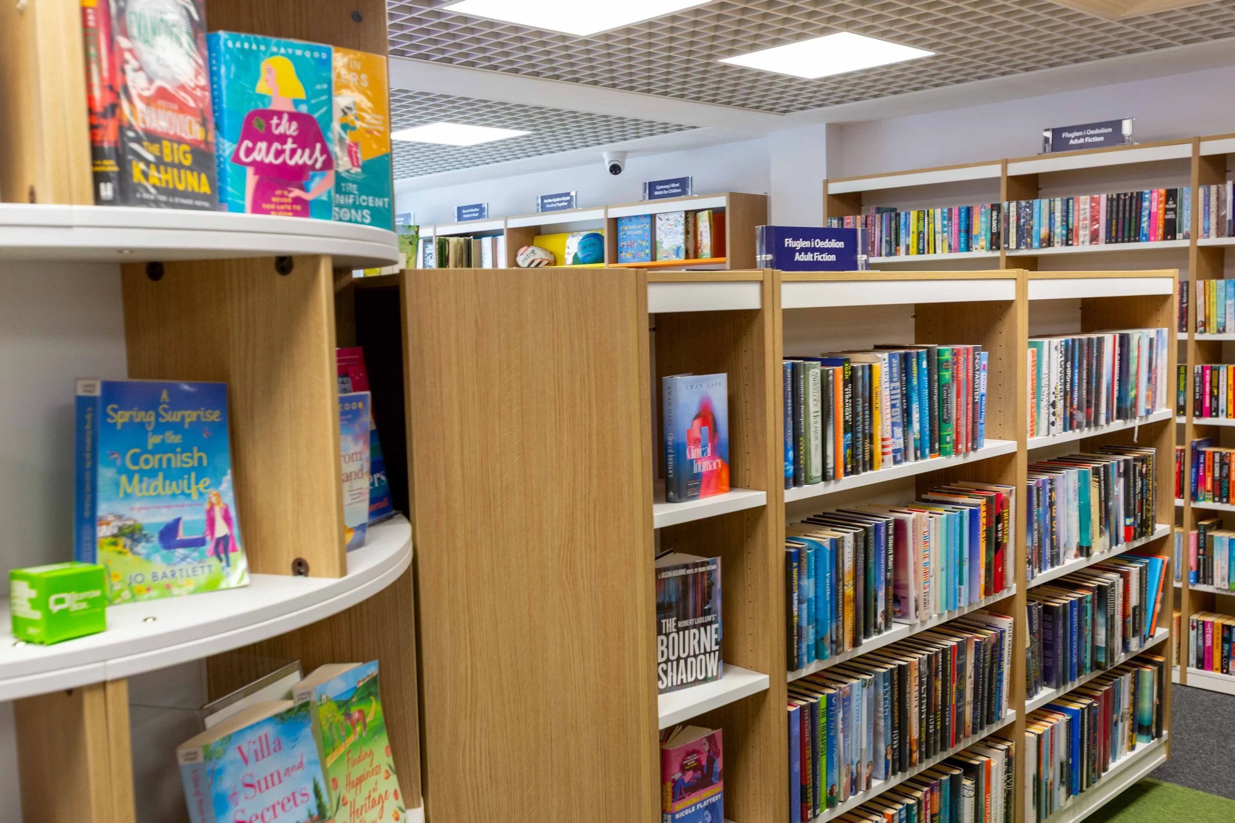 Bookshelves filled with various books in a library or bookstore.