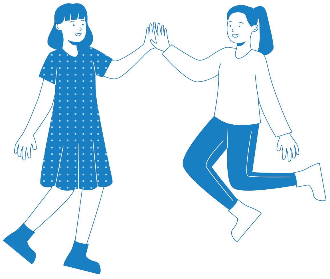 Two girls giving each other a high five, smiling, one in a polka dot dress and boots, the other in a long-sleeve shirt and jeans, jumping with happiness.