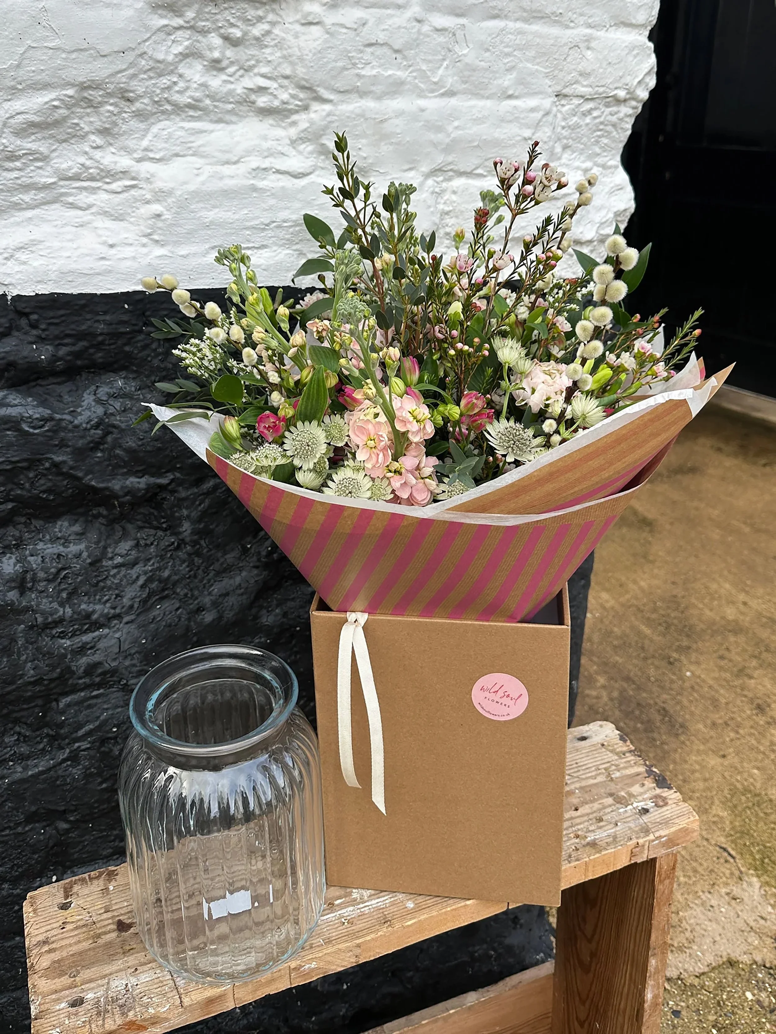 A seasonal hand tied bouquet, complete with vase, by Wild Soul Flowers