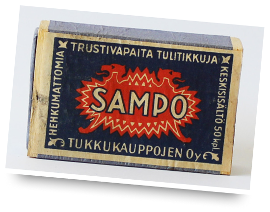 En vintage tändsticksask med svart bakgrund och ordet "SAMPO" i fet röd och vit text tvärs över mitten. Asken har finländsk text och illustrationer av drakar och dekorativa element.
