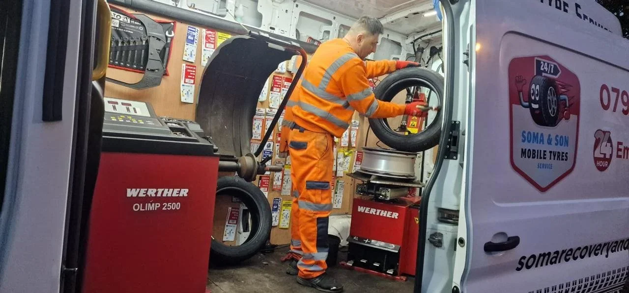24/7 mobile tyre repair being carried out roadside for a stranded driver.