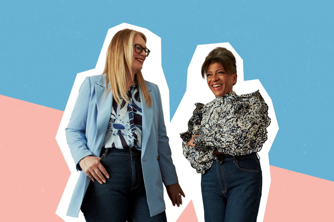 Stock image: Two women stand laughing together