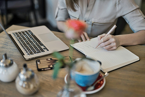 woman writing goals in therapy