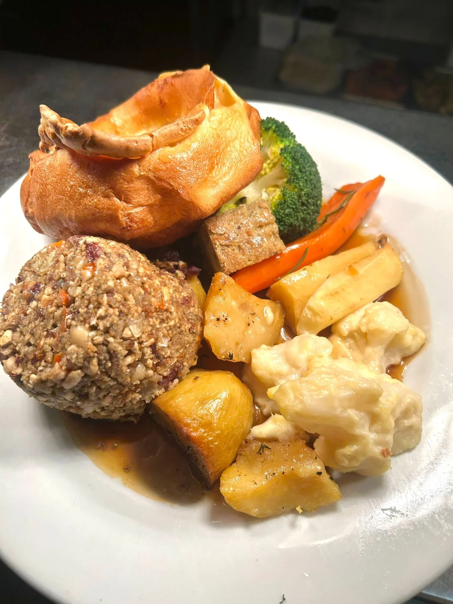A vegetarian nut roast, with cauliflower cheese, roasted vegetables, Yorkshire pudding, stuffing and gravy