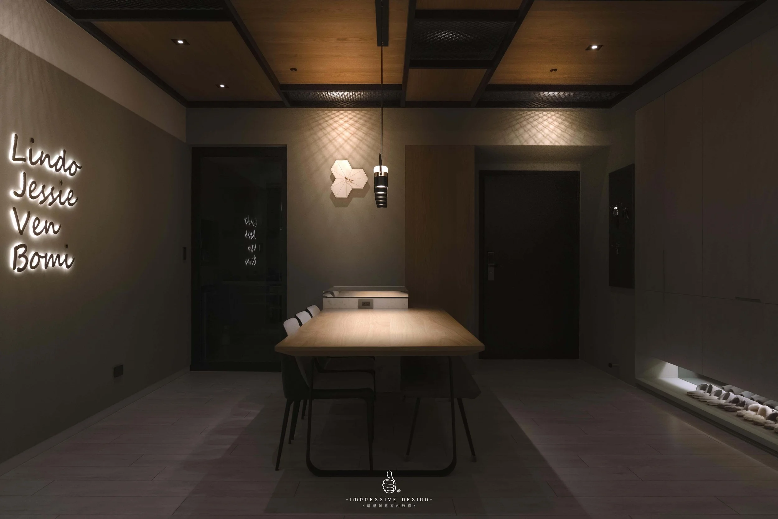 Minimalist dining room with wooden table, black chairs, wall neon sign with names, and decorative wall lights and shoes displayed along the bottom right