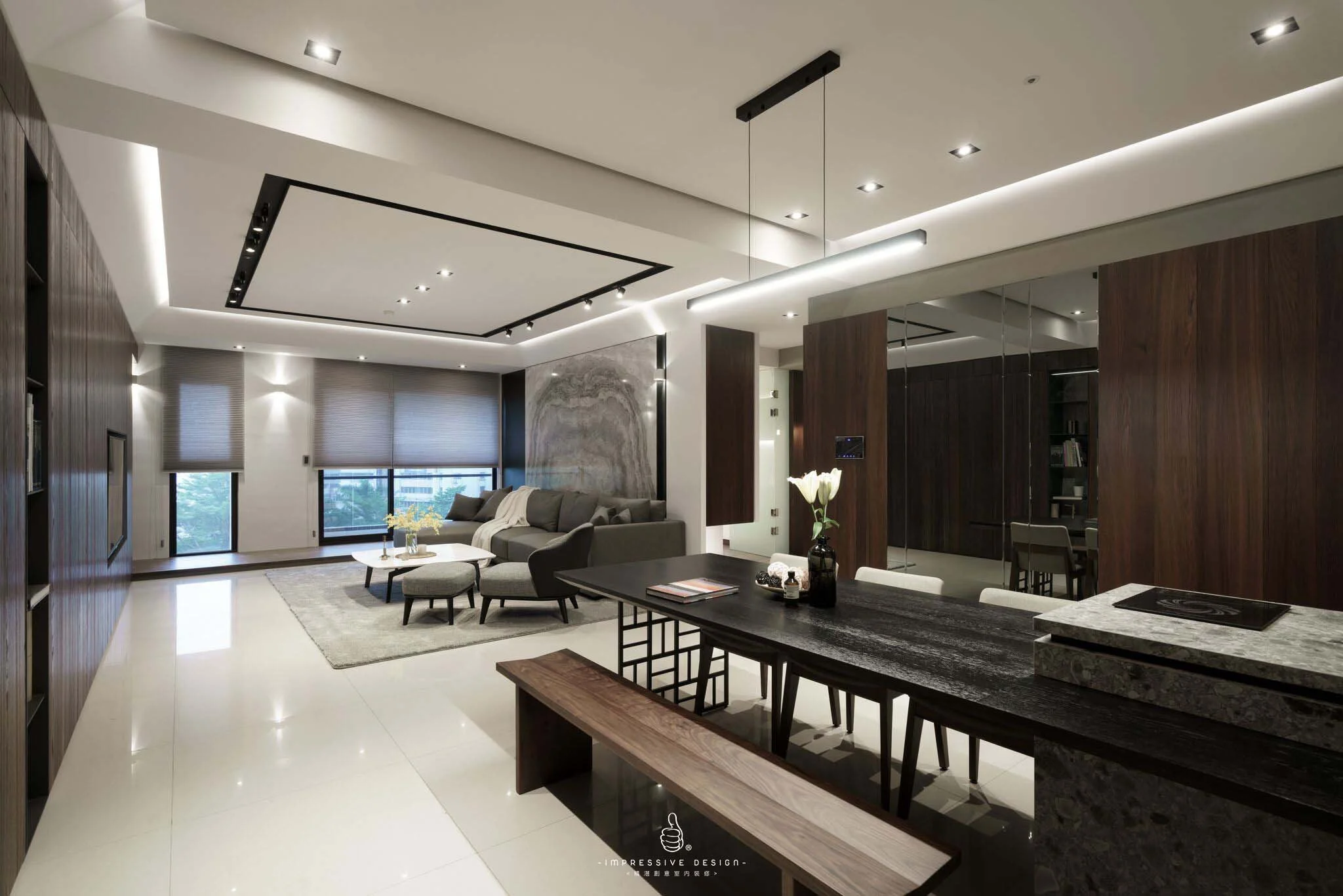 Modern living room with neutral tones, gray sofa, marble wall art, large windows with blinds, and a sleek black dining table with white chairs.