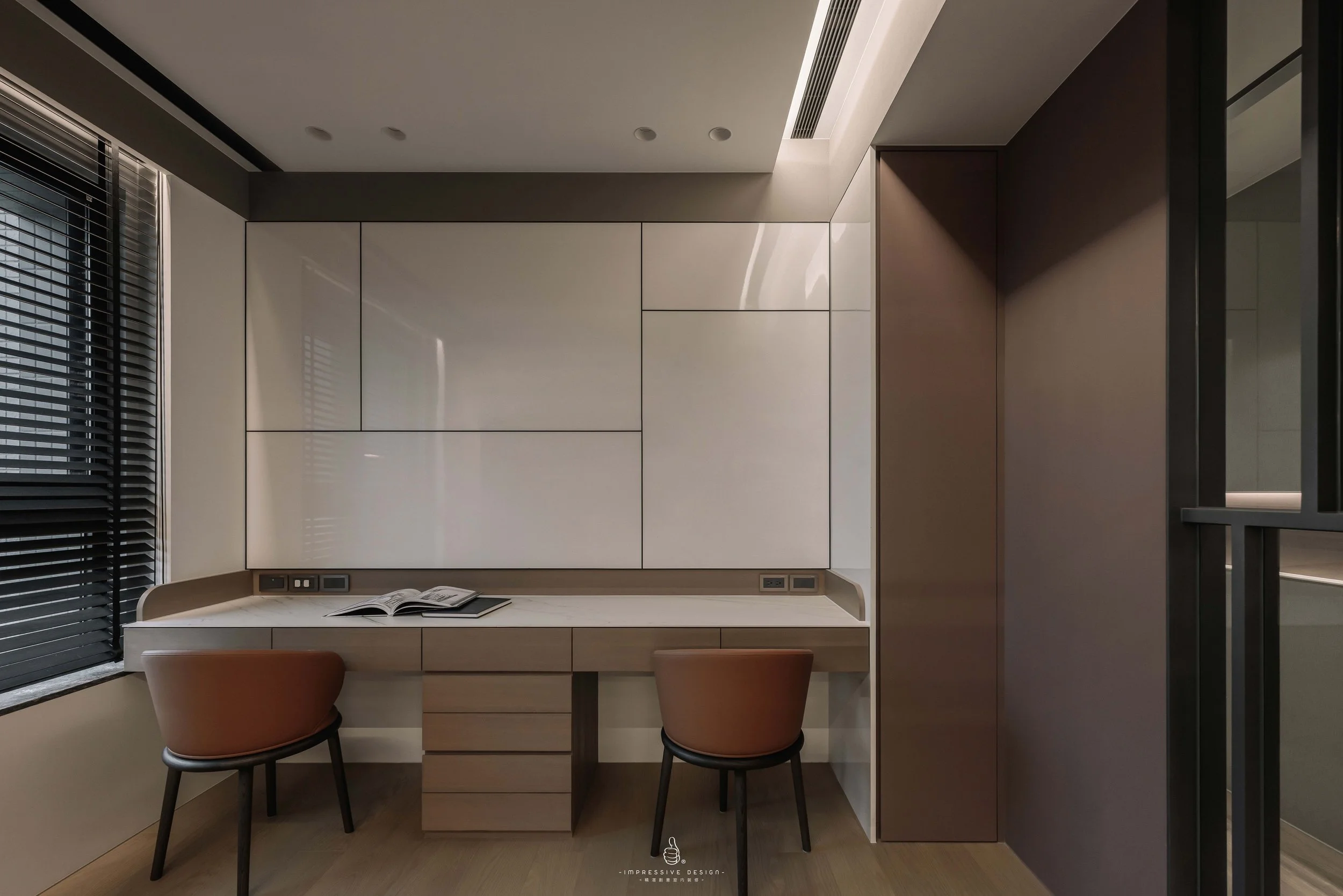 Modern workspace with a desk, two chairs, a whiteboard, and a window with black blinds.