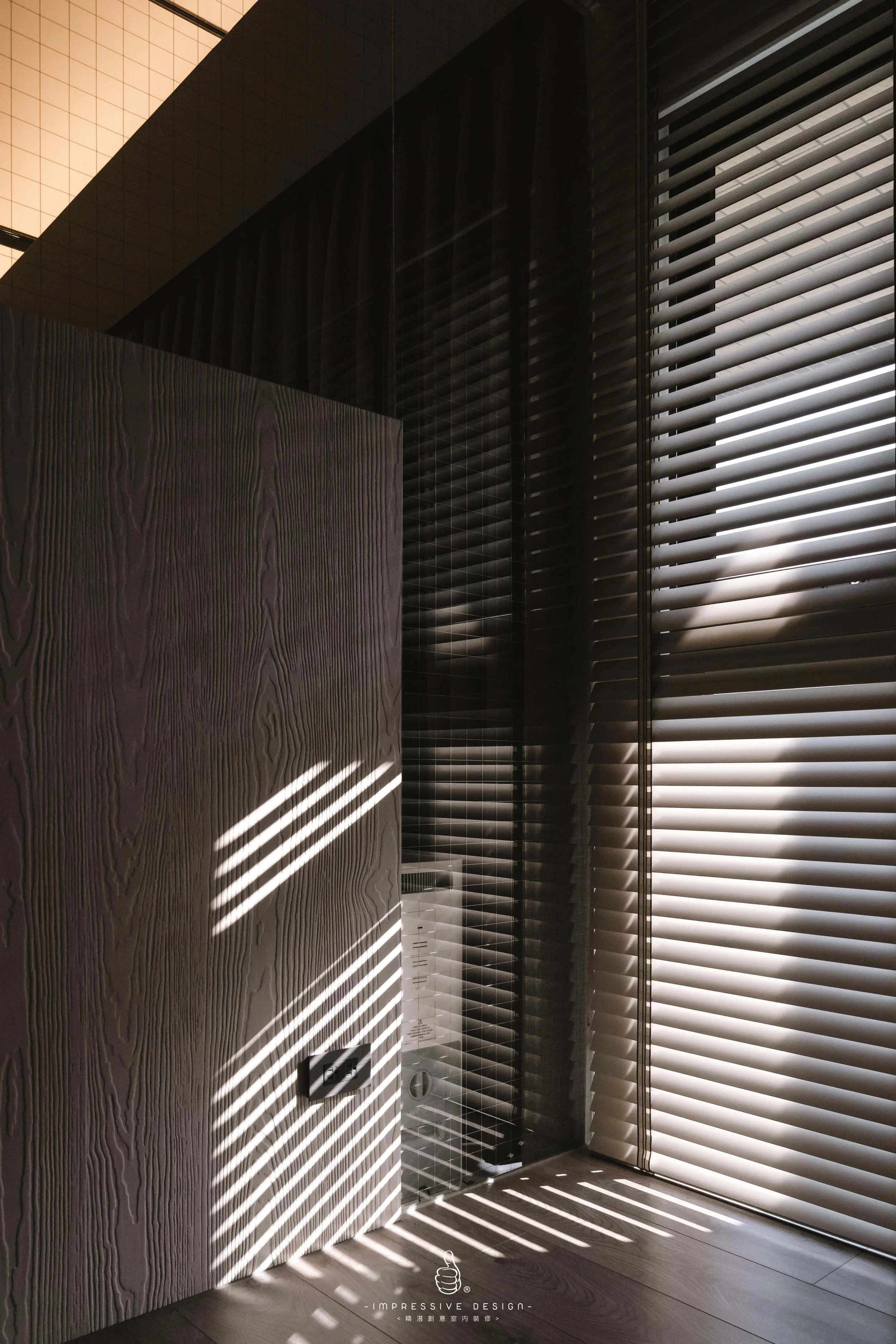 Sunlight passing through window blinds creating striped shadows on a wooden surface in a modern room.