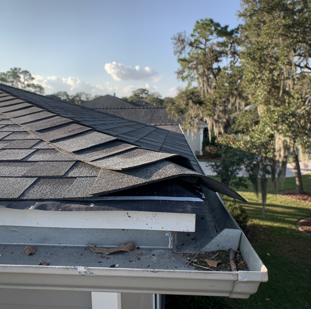 aerial view of hurricane-damaged roof with missing shingles