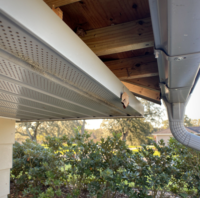 worn wooden soffit panel gaping under roof overhang