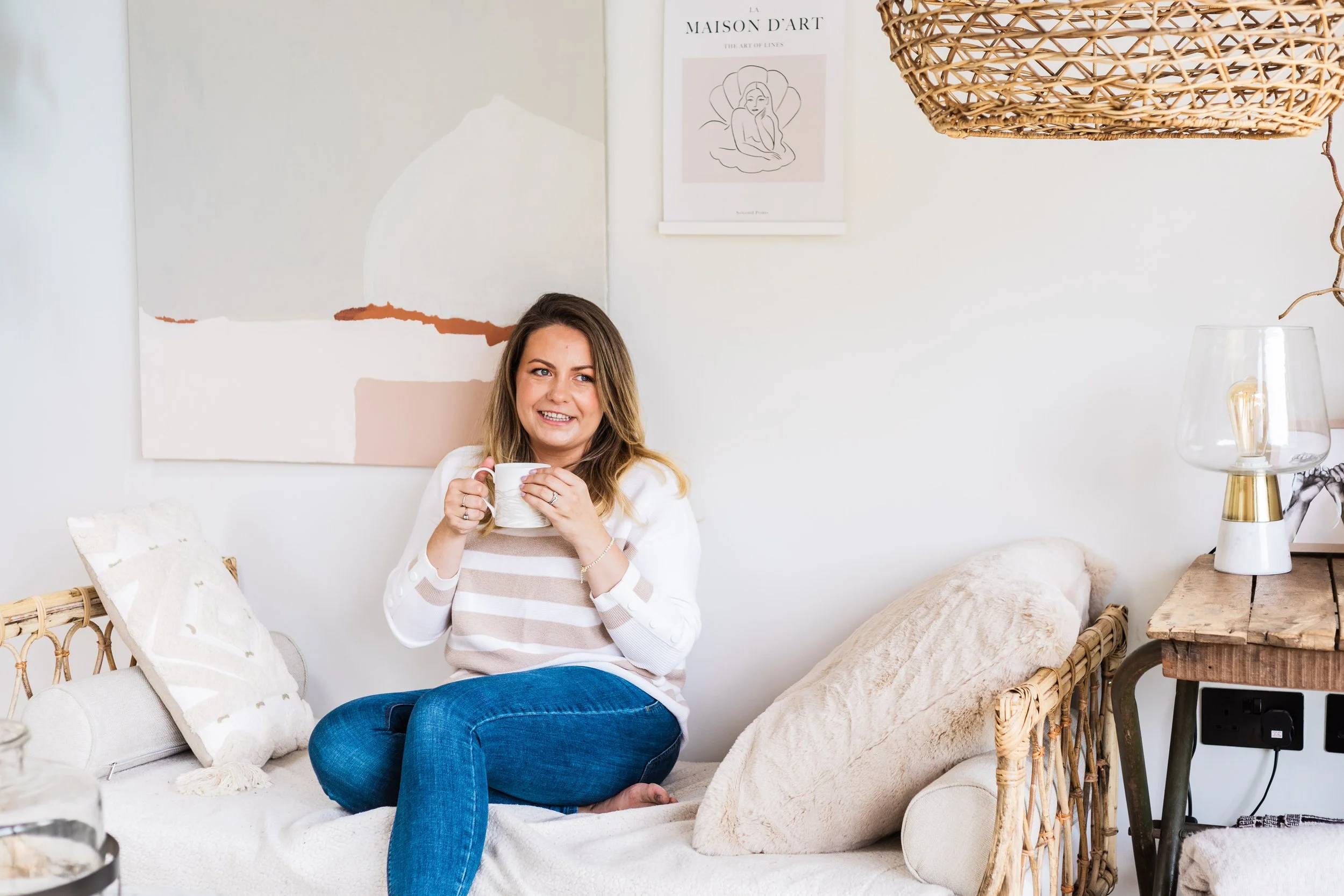 Keri Rock, founder of Sleepy Mums, holding a mug in a cozy home setting with the text 'You don't have to figure this out alone.'
