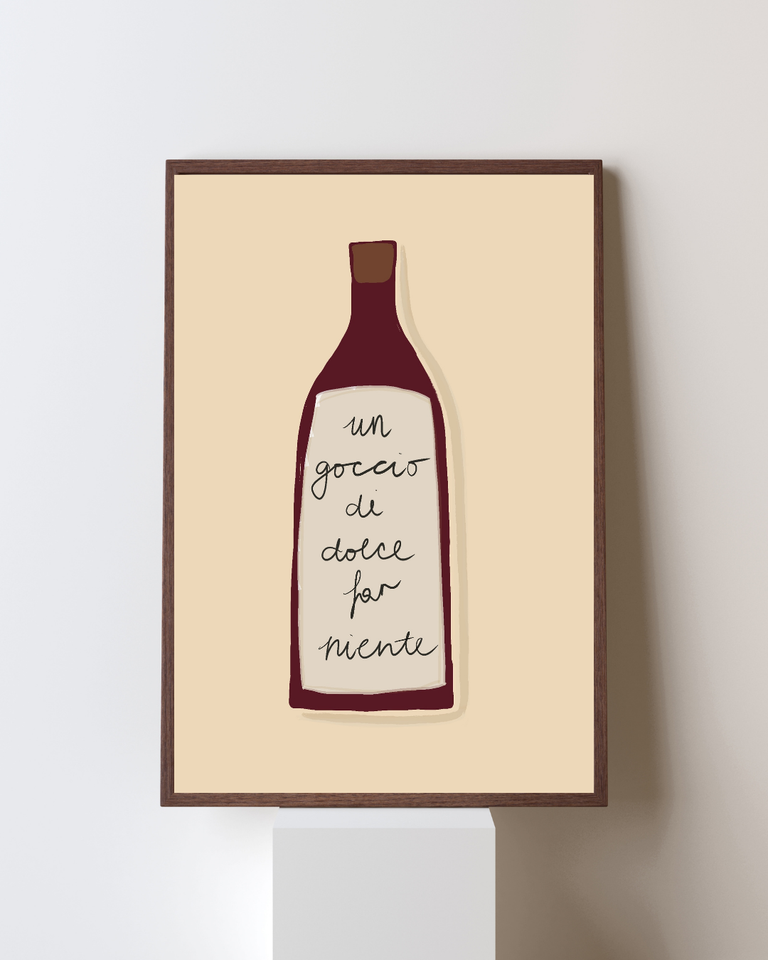 A framed minimalist illustration of a bottle with a handwritten Italian phrase on the label that says "un goccio di dolce far niente."