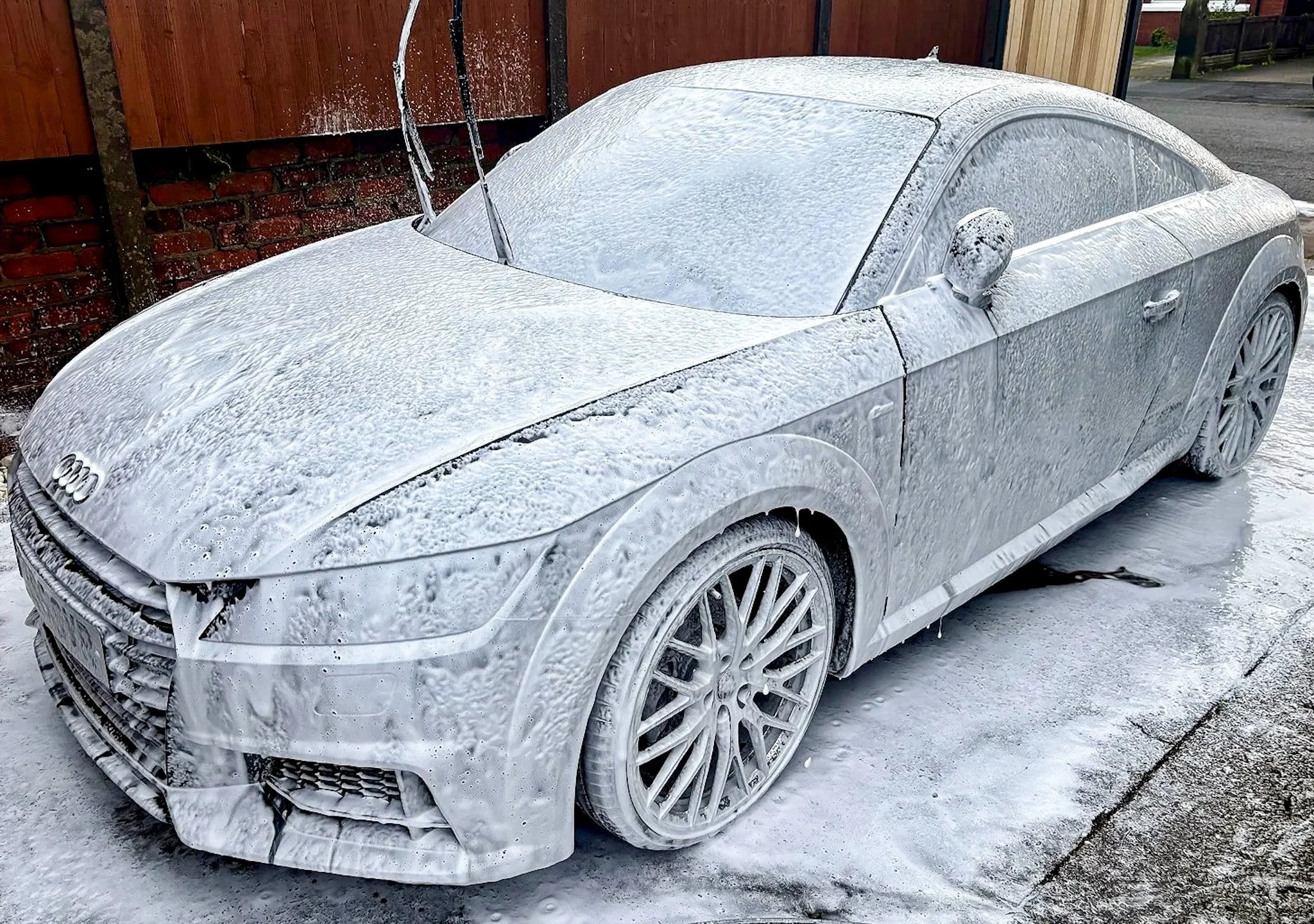 An Audi TT in the middle of a snow foam pre wash