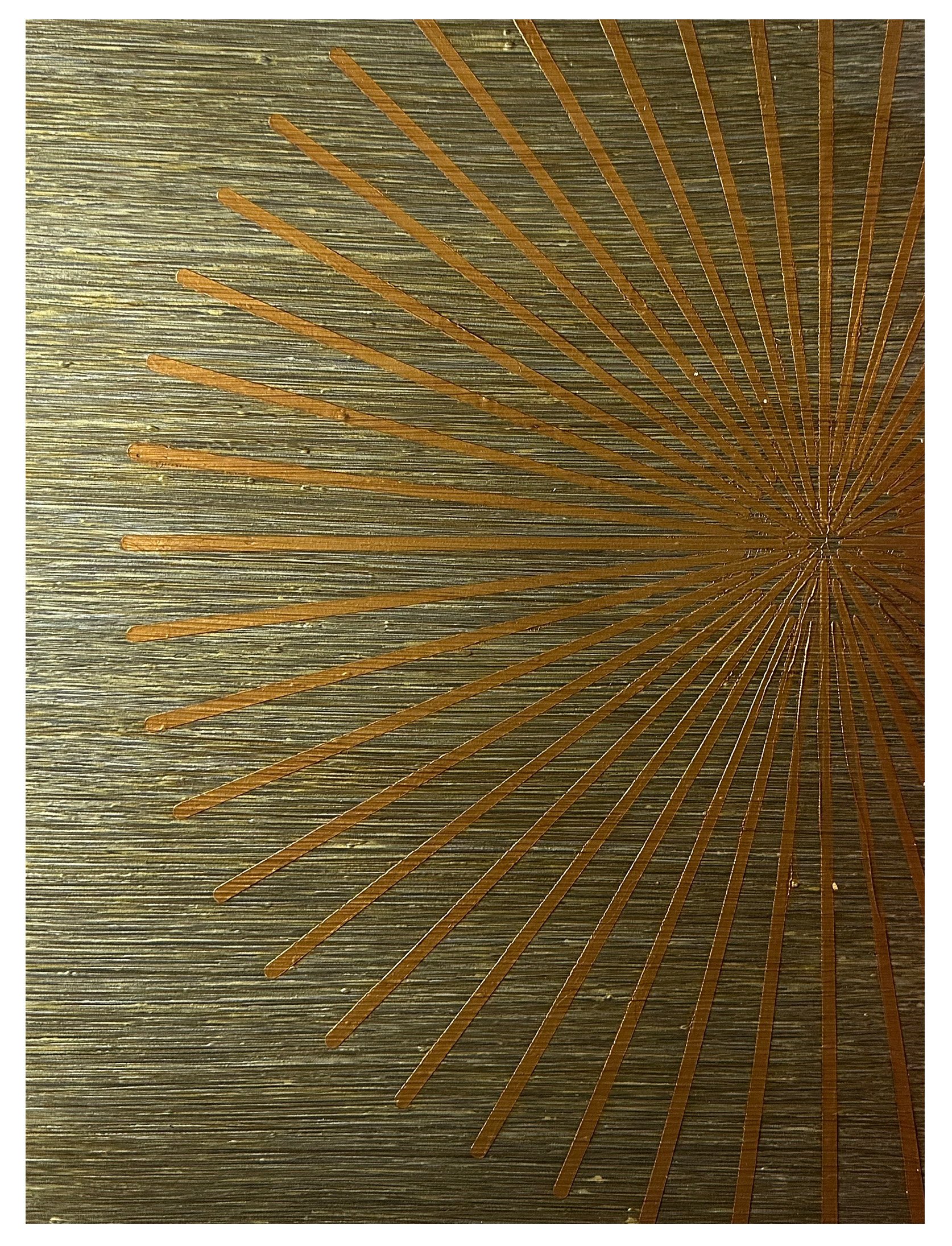 Close-up of a decorative wooden surface with an intricate carved starburst pattern.