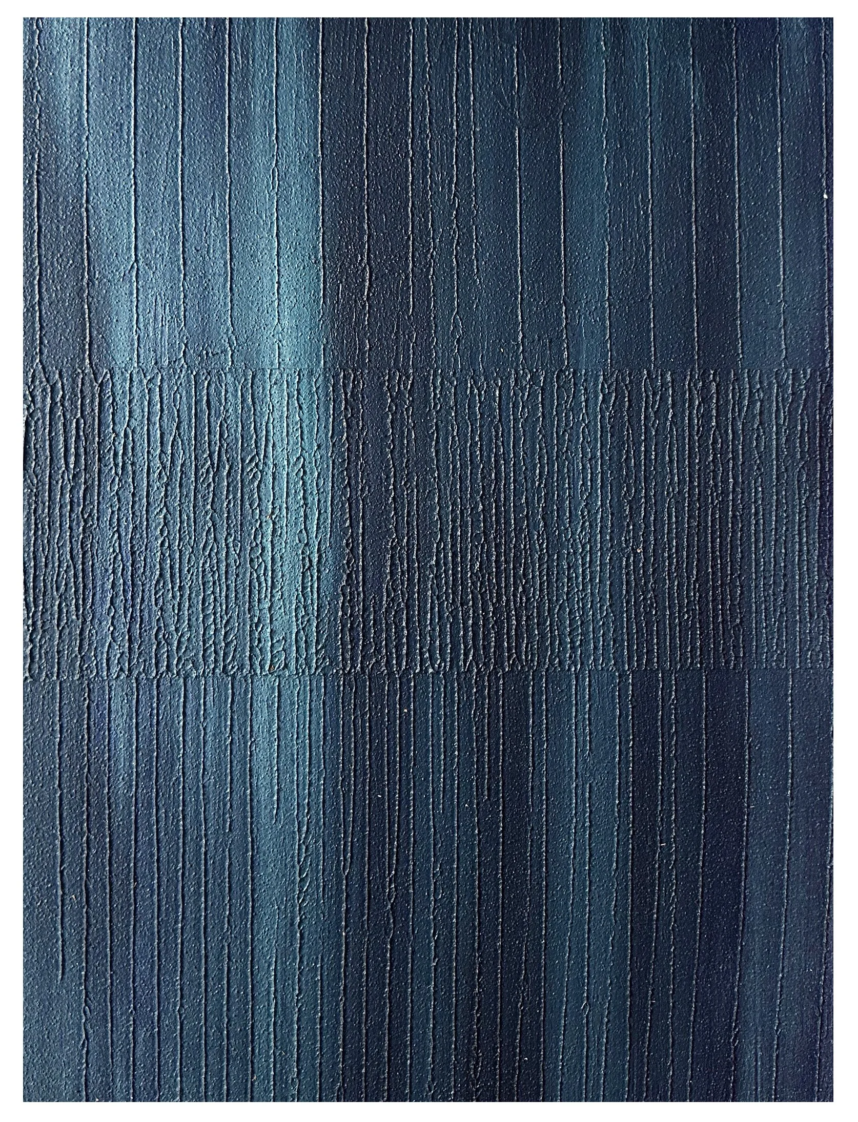 Close-up of textured surface with vertical lines and a gradient of blue hues, creating a abstract pattern.