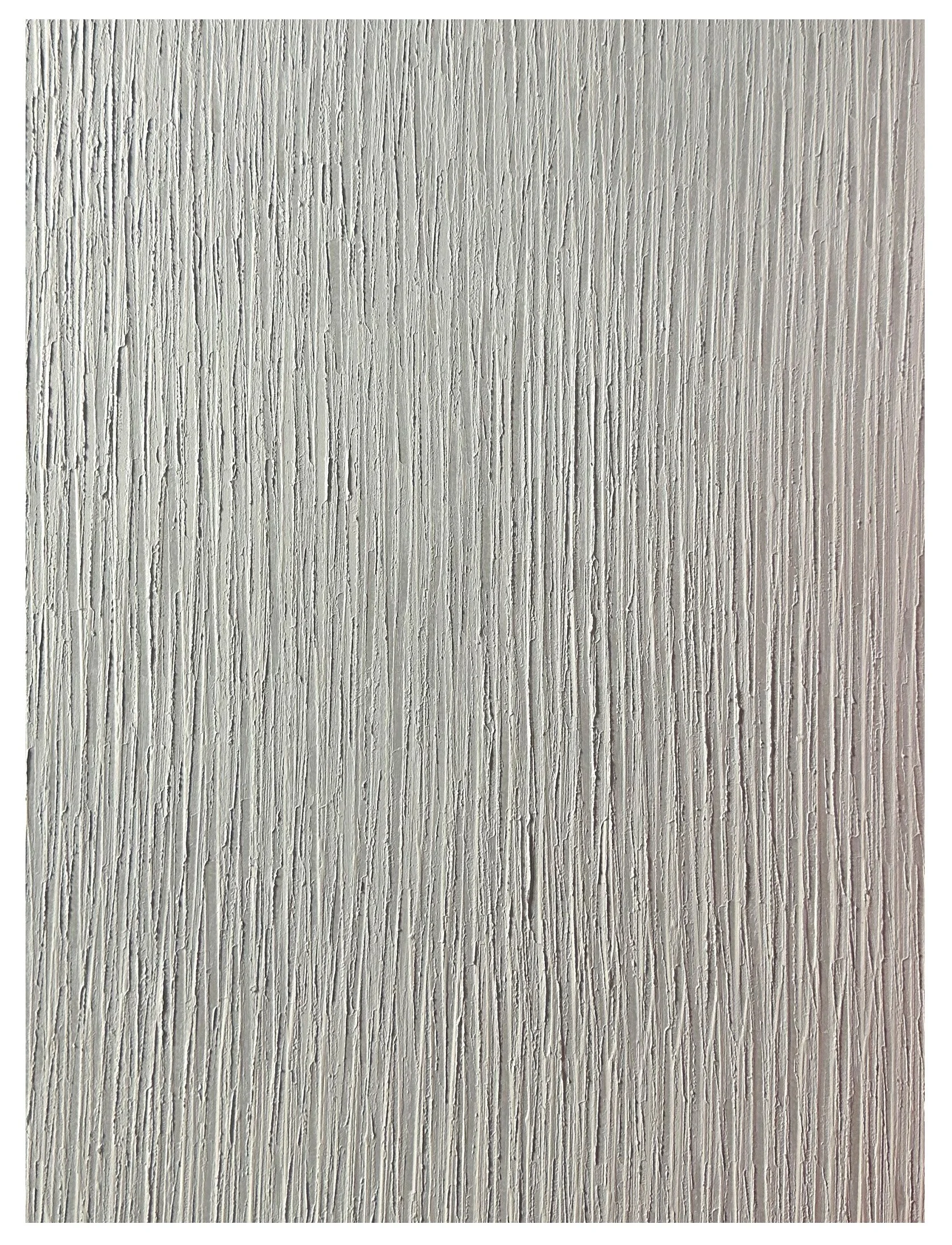 Close-up of a textured wall with vertical lines and a rough surface.