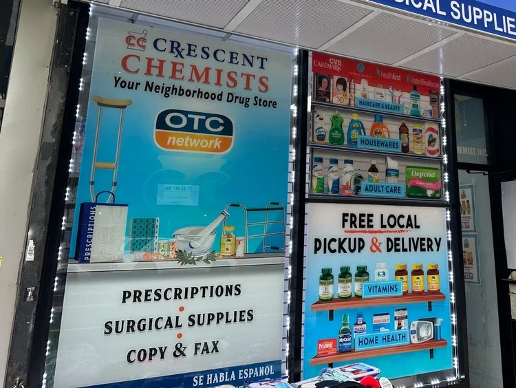 Signboard for Crescent Chemists, a neighborhood drug store offering prescriptions, surgical supplies, copy and fax services, with free local pickup and delivery.