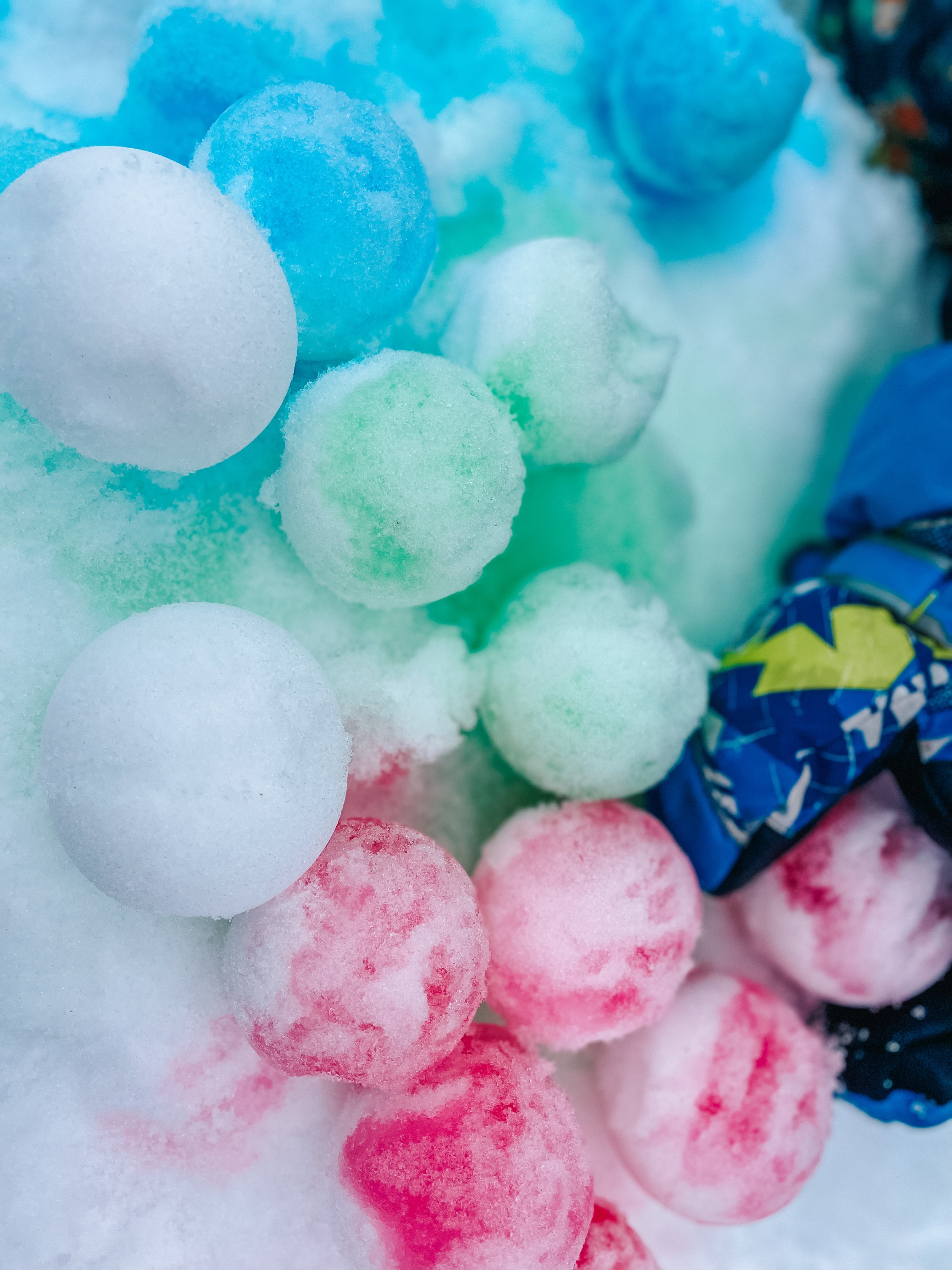 Colorful snowballs in shades of white, blue, green, and pink.