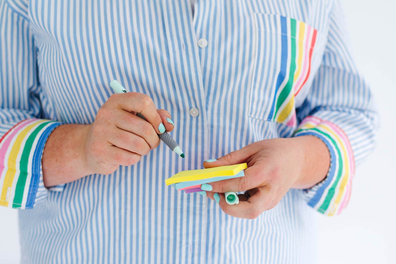 Lindsay Brady of The Big Life Project in a stripy shirt, writing on a post-it