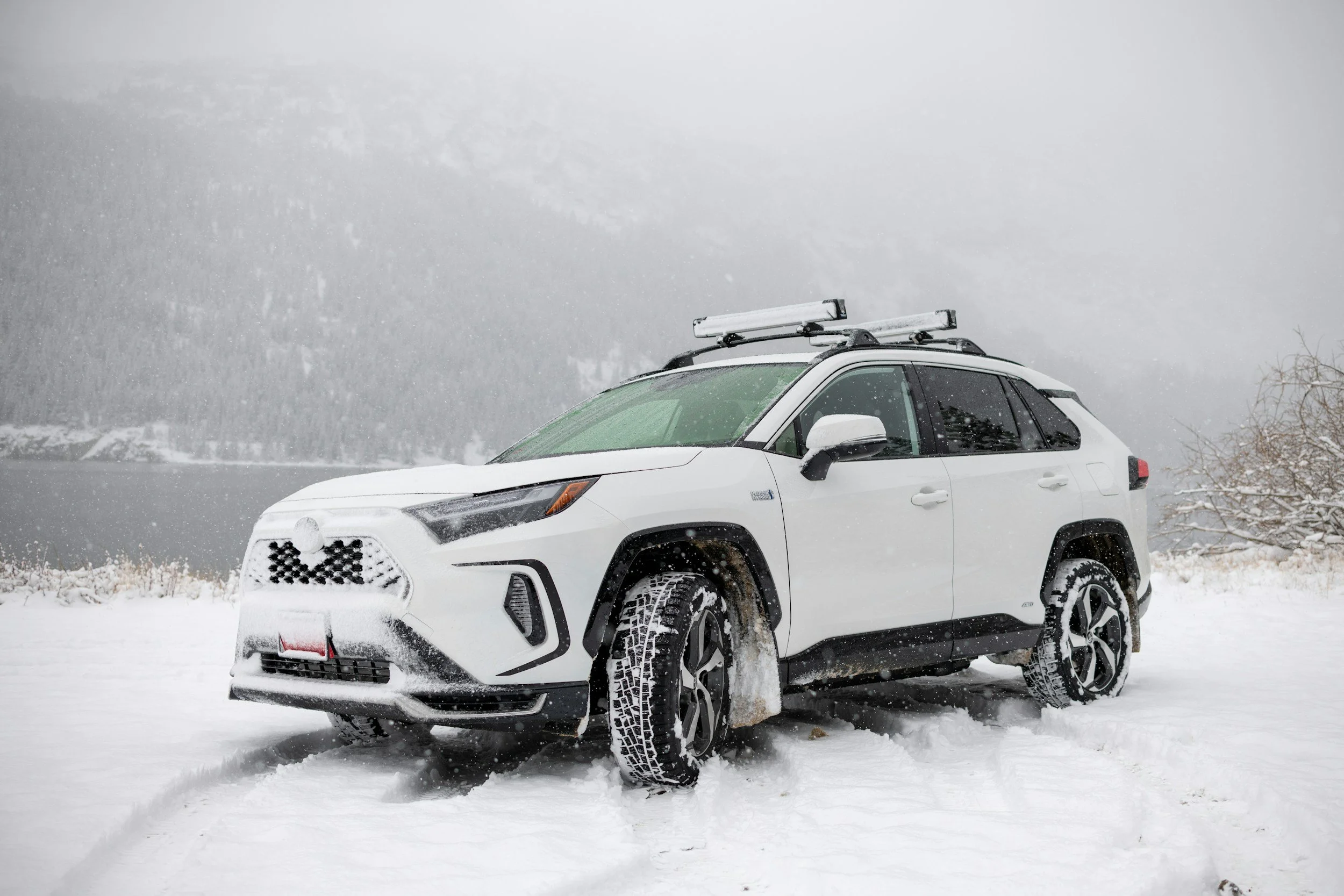 White Subaru in a snowy Colorado mountain setting