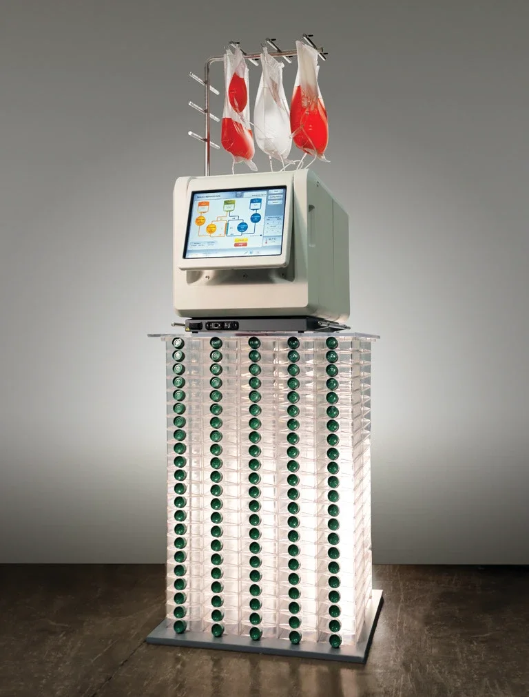 The Quantum cell expansion medical device placed on a display stand with manual Flasks.
