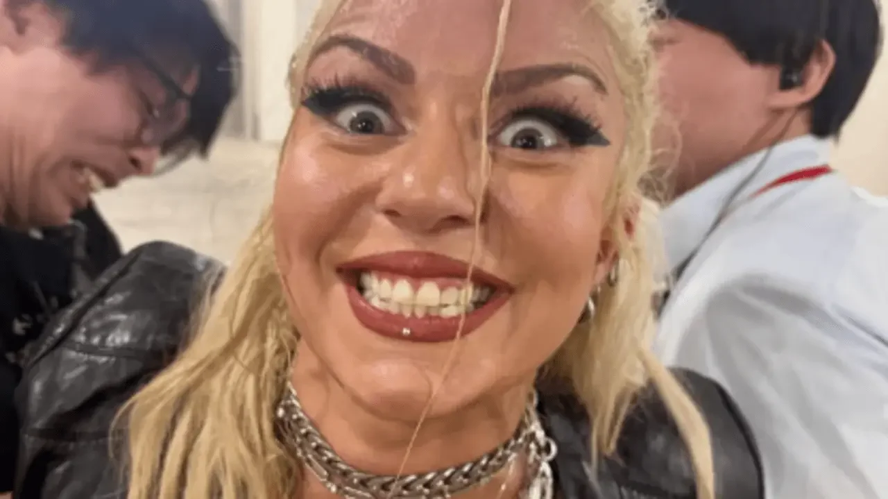 Close-up selfie of AEW star Thekla making an intense, unhinged wide-eyed expression and grinning directly into the camera backstage.