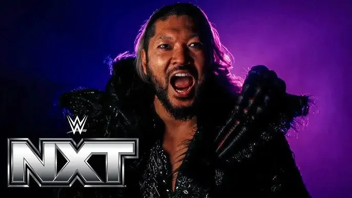 WWE NXT wrestler Naraku shouting with a fierce expression, wearing dark gear against a dramatic purple and blue lighting background with the WWE NXT logo in the bottom left corner.