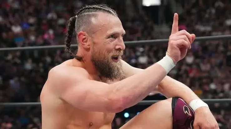Bryan Danielson pointing to the sky in the ring during an AEW event.