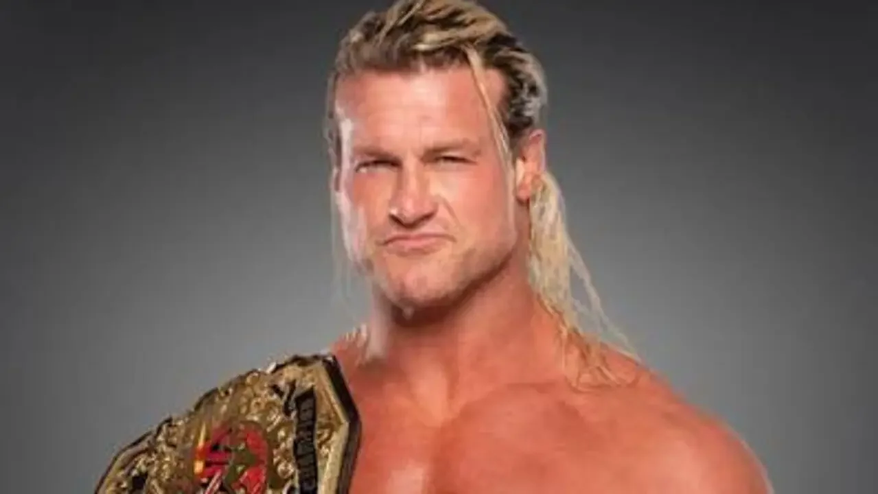 A promotional portrait of the professional wrestler Nic Nemeth. He has long, blonde, wet-look hair and is making an intense, smirking facial expression towards the camera.