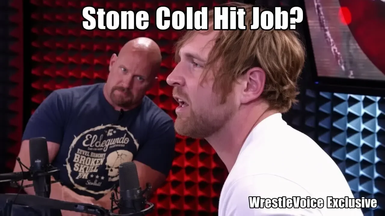 Two men in a podcast studio with red acoustic foam walls. On the left, a bald man with a goatee wearing a dark blue “El Segundo Broken Skull” T-shirt looks intently at the man on the right.
