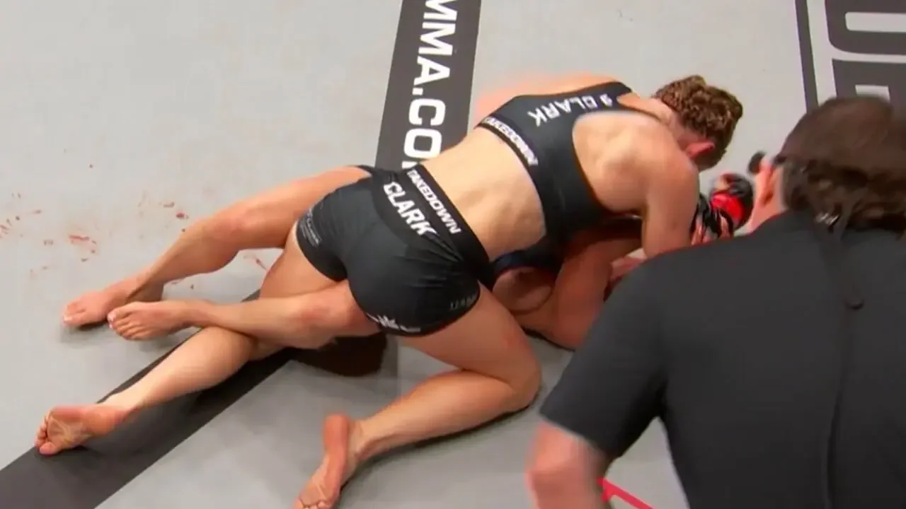 Lucero Acosta, MMA fighter, in the midst of a wardrobe malfunction.